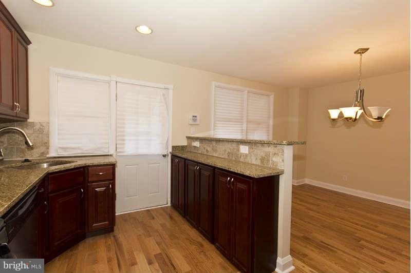 4230 Colborne Road Baltimore, MD 21229 - Photo 14 of 27 a kitchen with a sink and cabinets