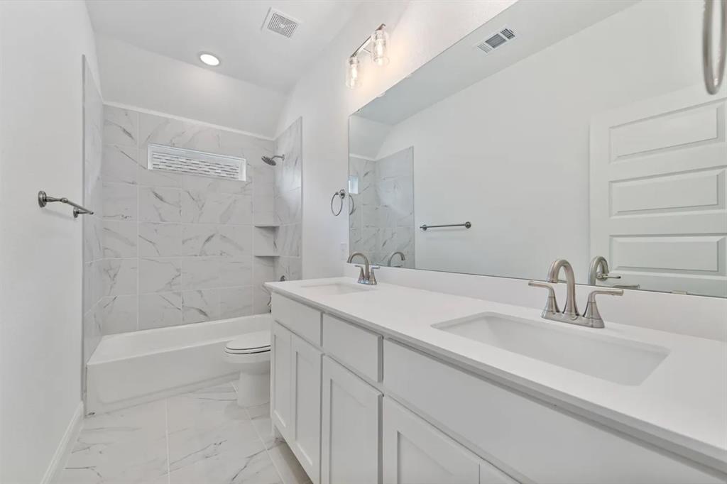 9337 Loggerhead Way Fort Worth, TX 76118 - Photo 34 of 40 a bathroom with a sink a toilet and shower