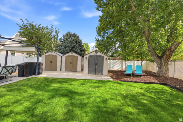 1816 River Bottom Road Springville, UT 84663 - Photo 31 of 37 Manicured lawn with three storage sheds on a concrete pad