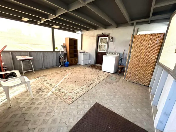 a view of a storage room with wooden floor and windows