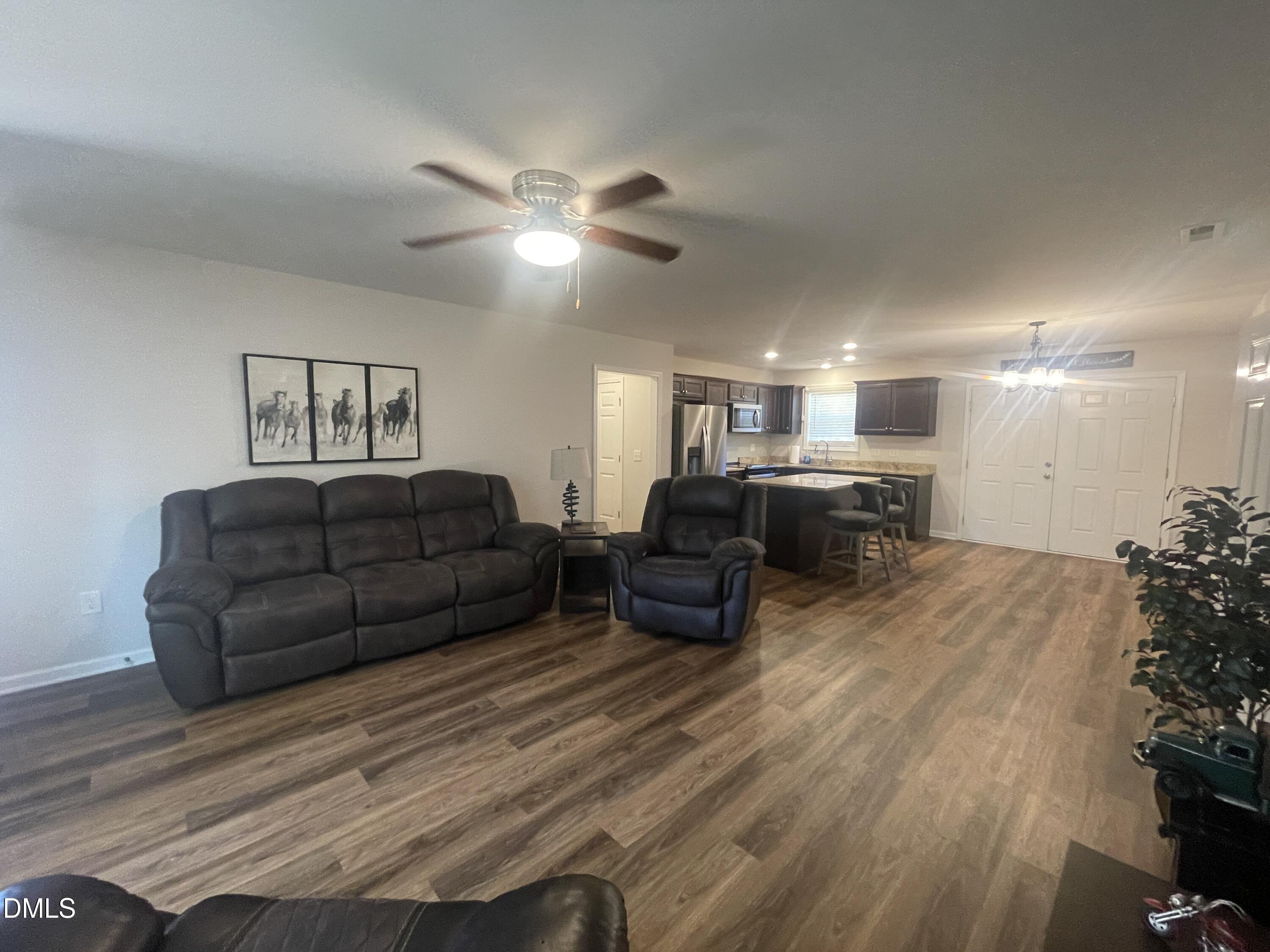 144 Red Hill Church Road Dunn, NC 28334 - Photo 13 of 44 a living room with furniture and a chandelier