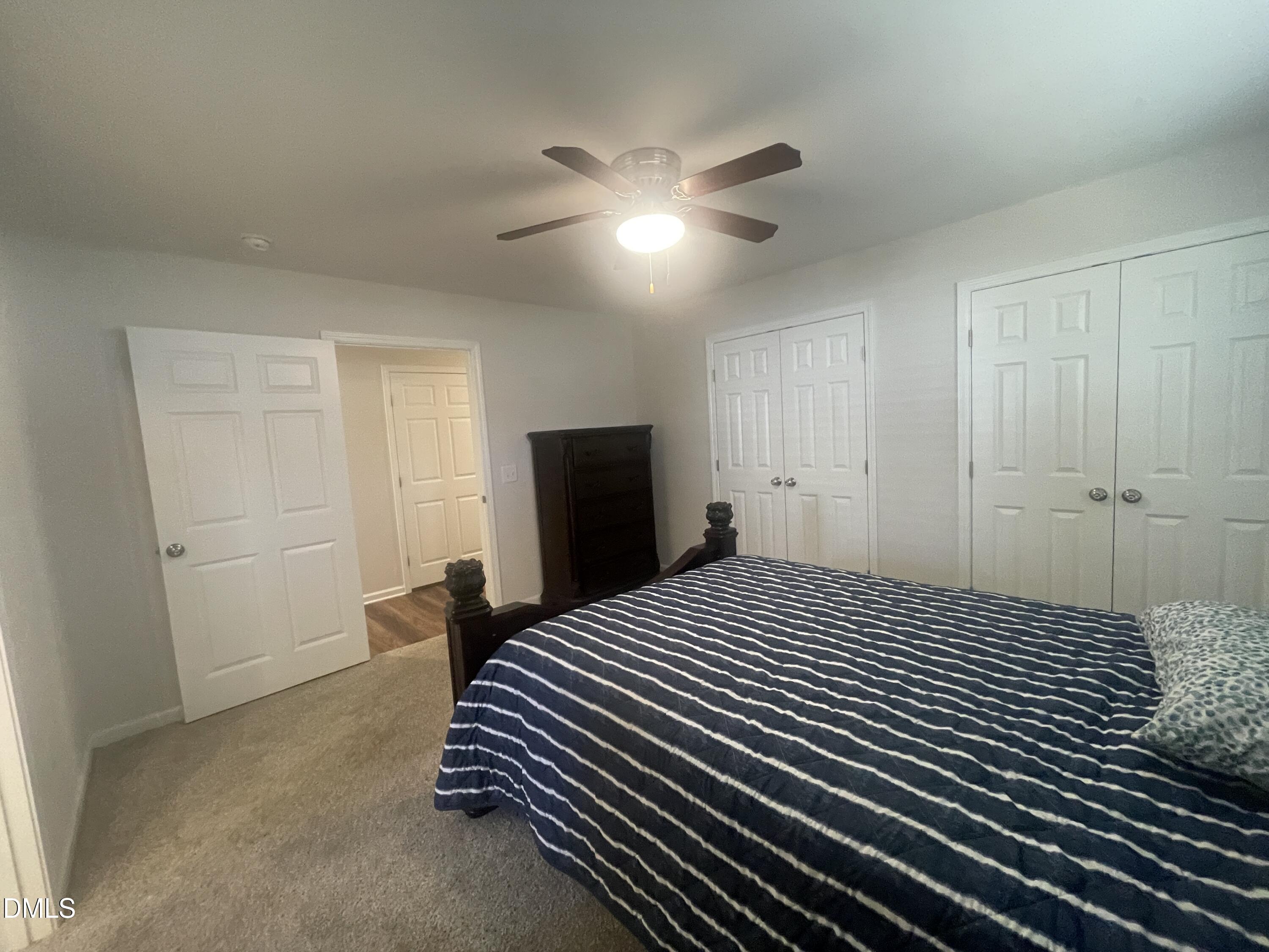 144 Red Hill Church Road Dunn, NC 28334 - Photo 26 of 44 a bedroom with a bed and a chandelier