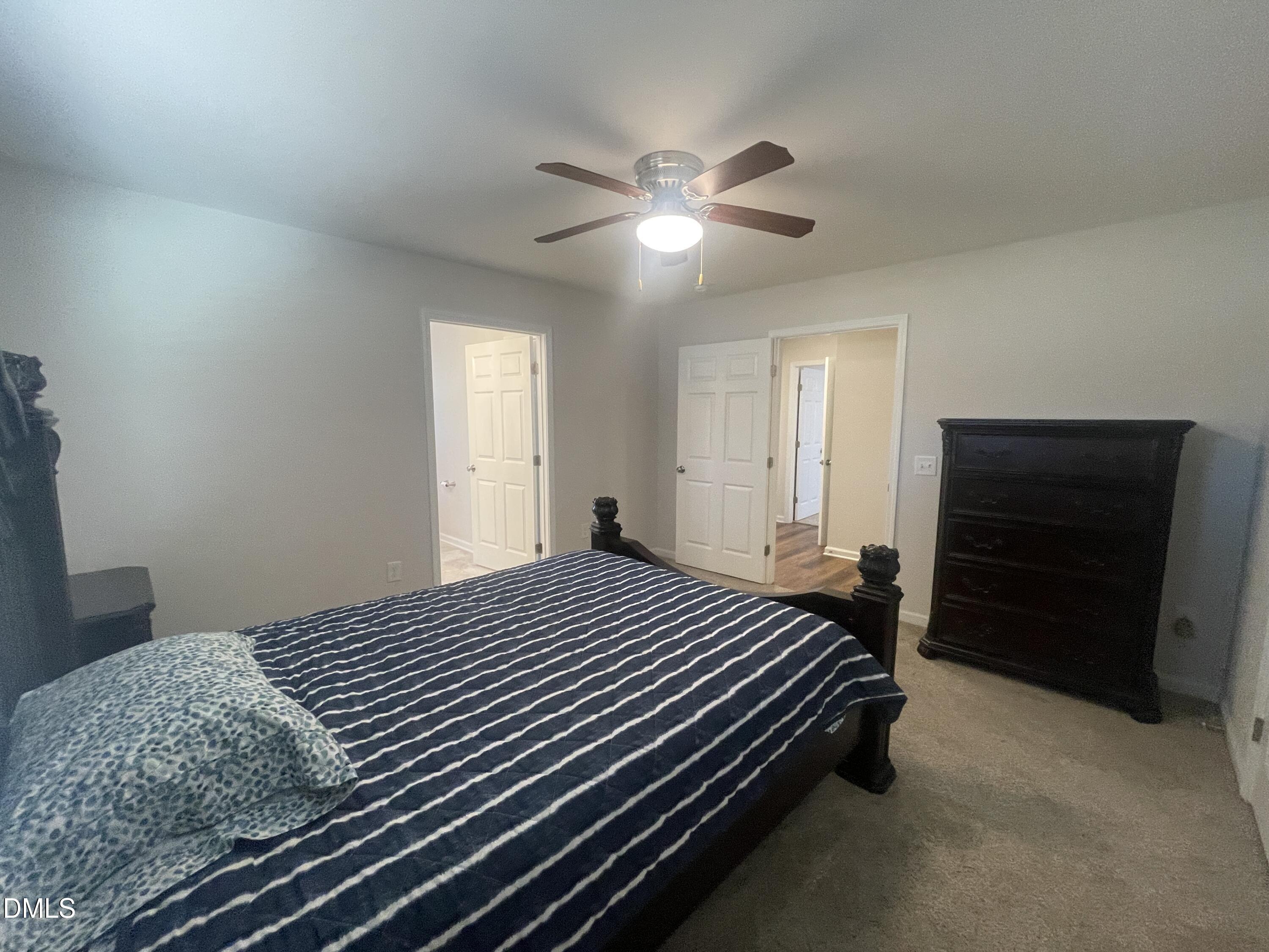 144 Red Hill Church Road Dunn, NC 28334 - Photo 27 of 44 a bedroom with a bed and a ceiling fan