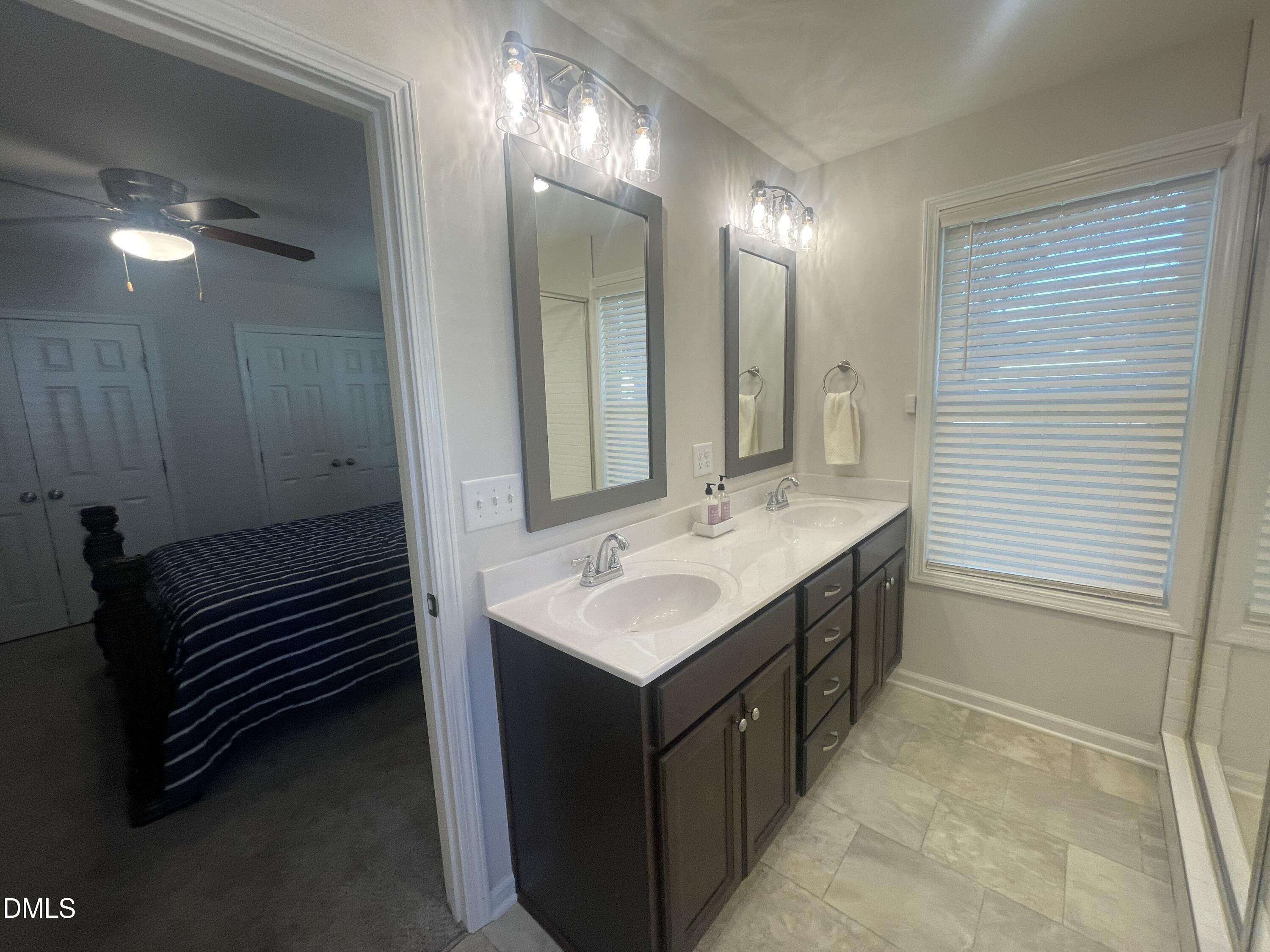 144 Red Hill Church Road Dunn, NC 28334 - Photo 29 of 44 a bathroom with a sink double vanity and a mirror