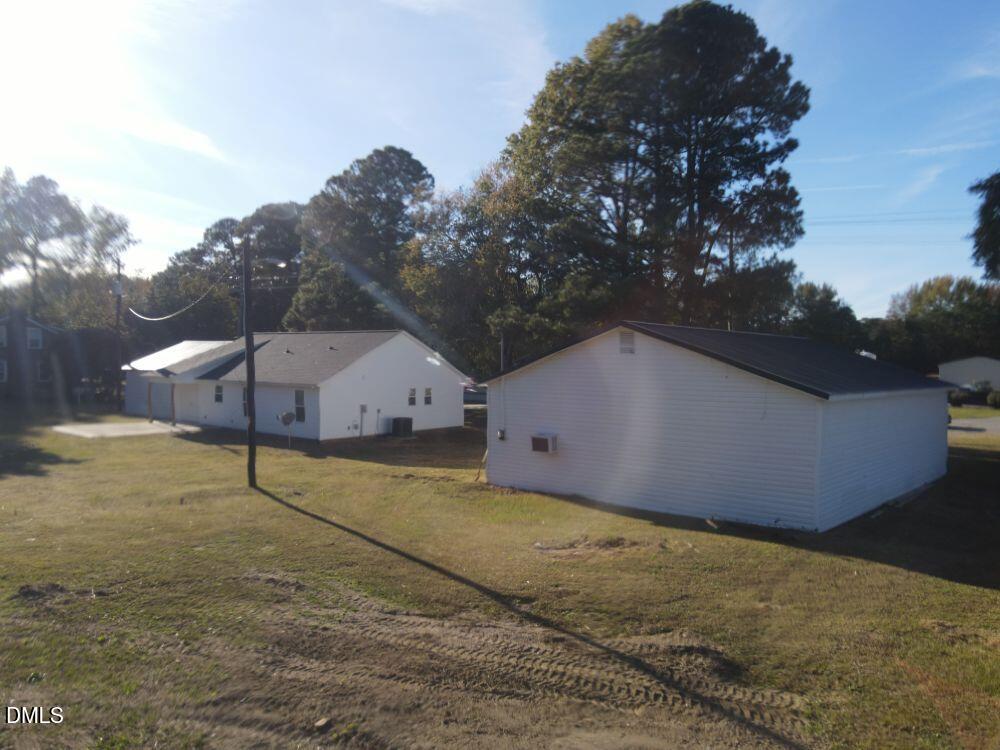 144 Red Hill Church Road Dunn, NC 28334 - Photo 3 of 44 a backyard of a house with large trees