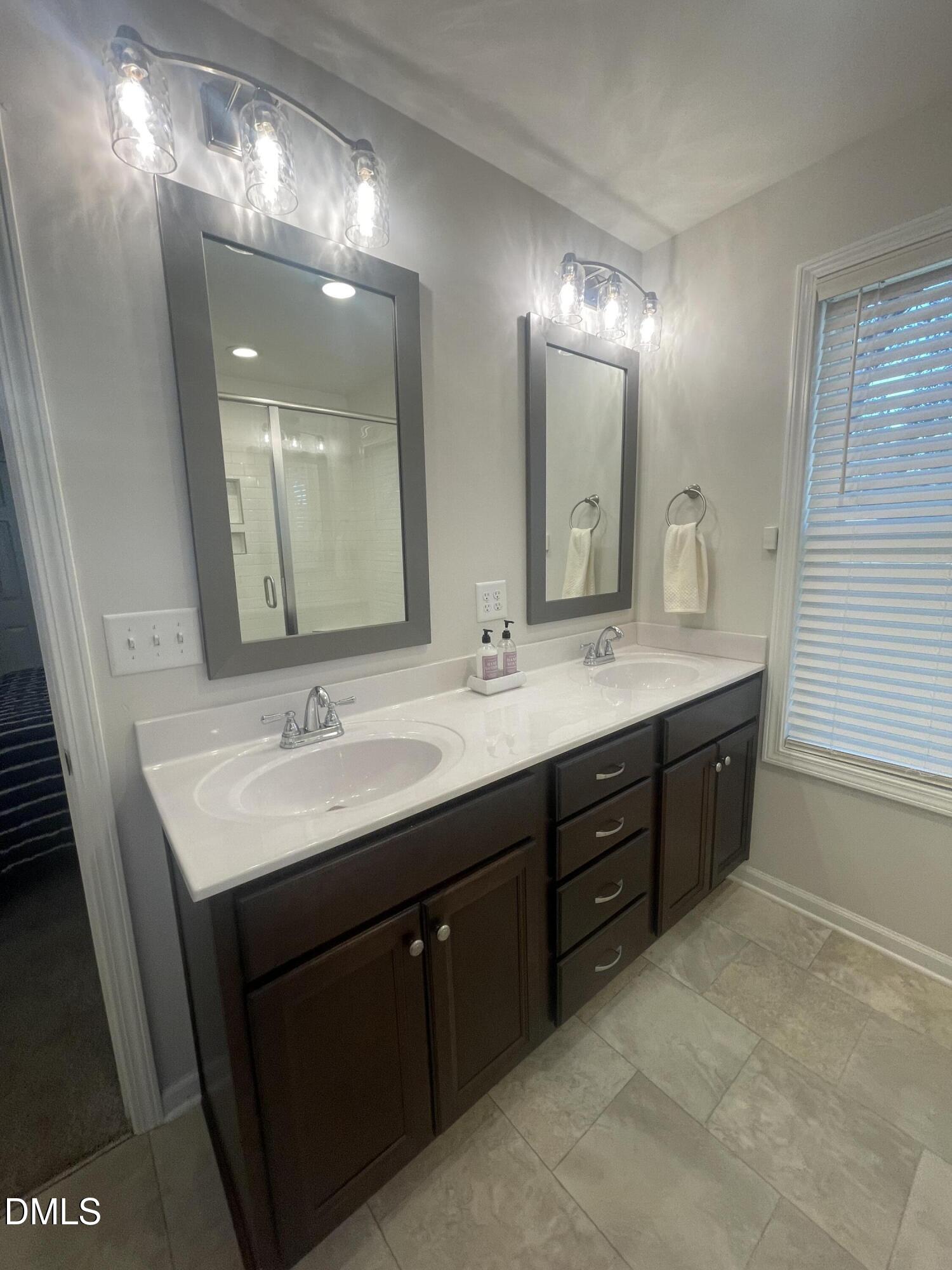 144 Red Hill Church Road Dunn, NC 28334 - Photo 31 of 44 a bathroom with double vanity a sink a large mirror and vanity