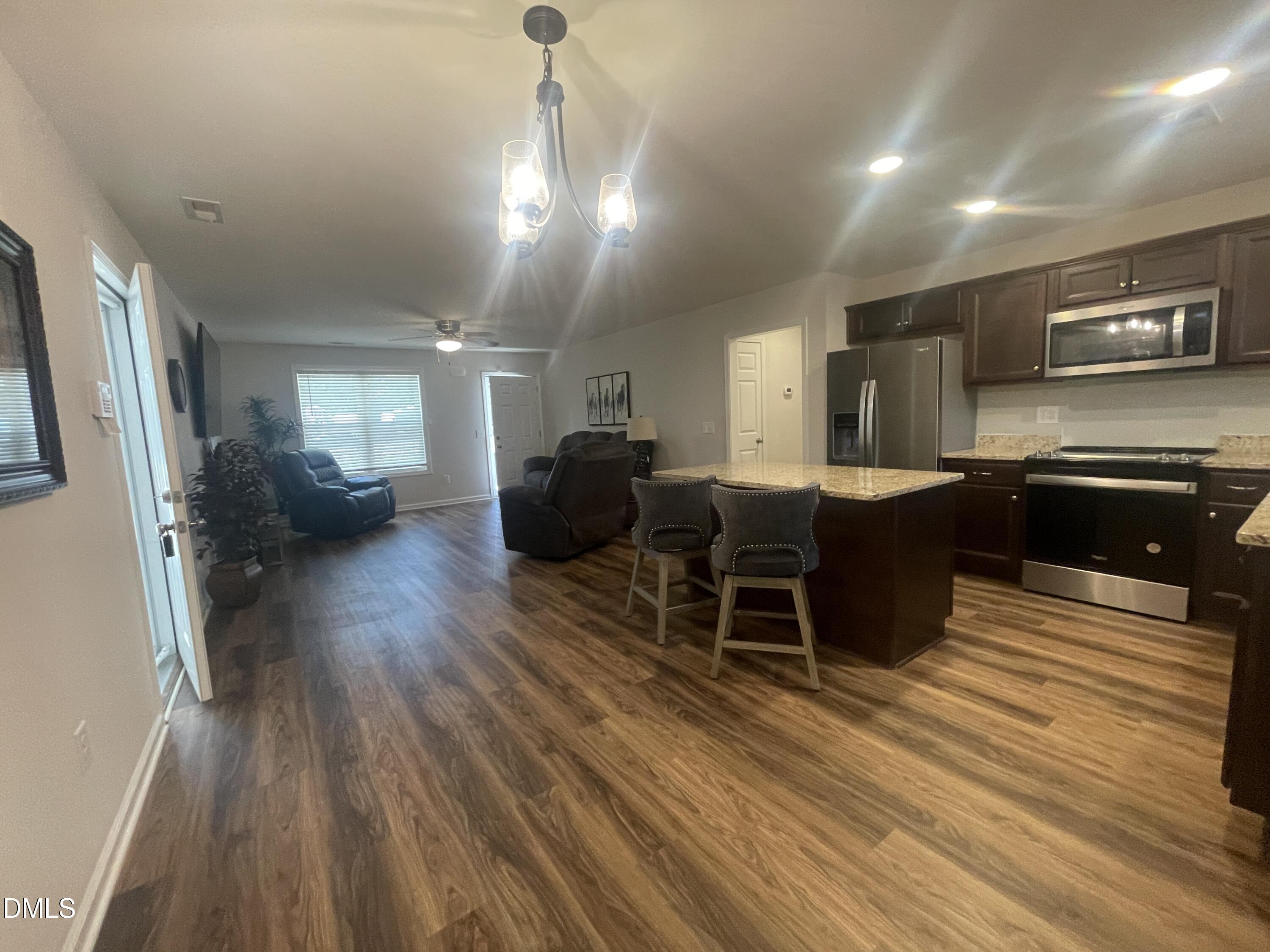 144 Red Hill Church Road Dunn, NC 28334 - Photo 9 of 44 a living room with furniture a large window and wooden floor