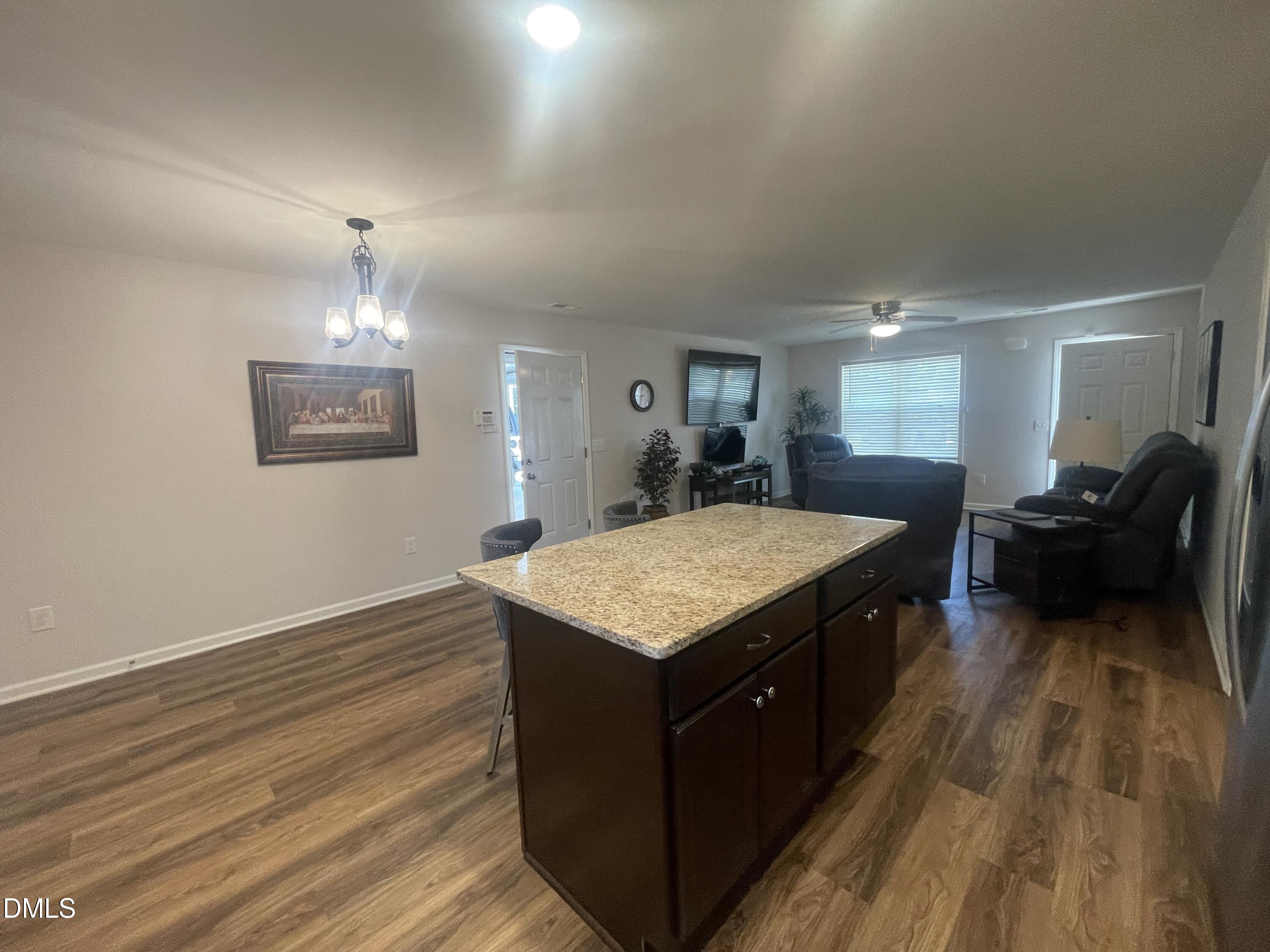 144 Red Hill Church Road Dunn, NC 28334 - Photo 10 of 44 a kitchen with a stove and a wooden floor