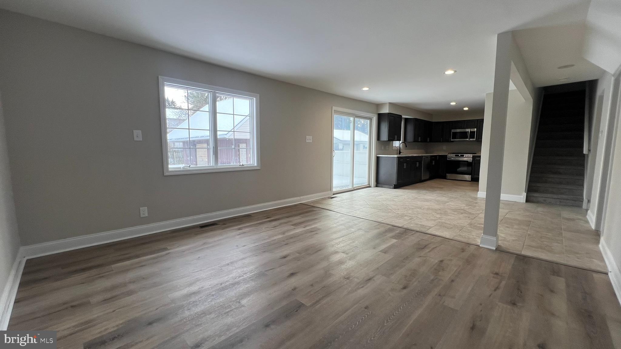 220 Harvard Avenue Stratford, NJ 08084 - Photo 11 of 33 an empty room with wooden floor and natural light