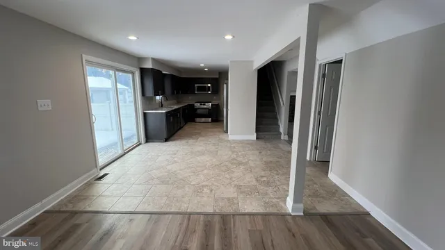 a view of hallway with furniture and wooden floor