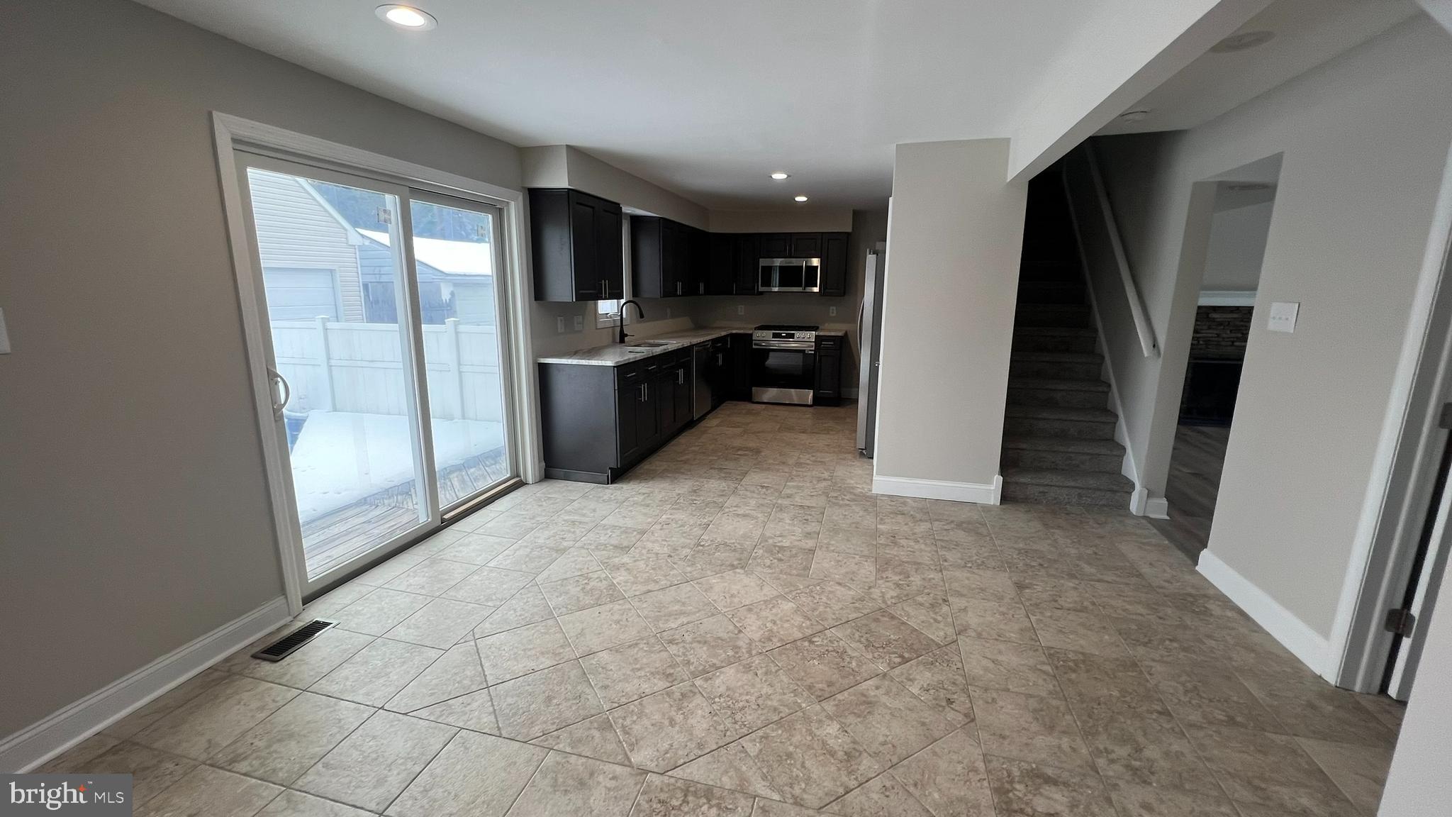 220 Harvard Avenue Stratford, NJ 08084 - Photo 13 of 33 a view of a kitchen with a sink and a refrigerator