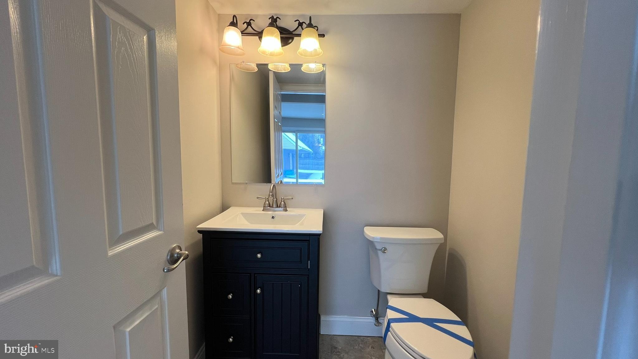 220 Harvard Avenue Stratford, NJ 08084 - Photo 15 of 33 a bathroom with a toilet sink and mirror