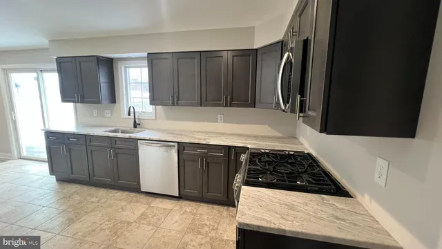 a kitchen with wooden cabinets and a stove top oven