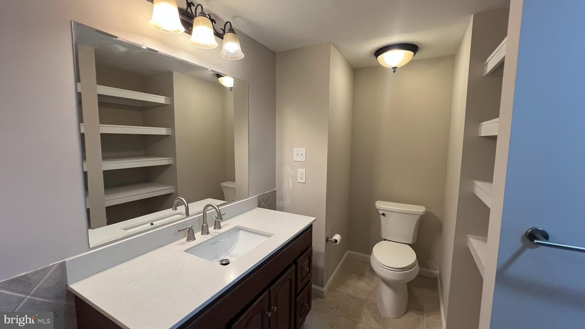 220 Harvard Avenue Stratford, NJ 08084 - Photo 24 of 33 a bathroom with a sink vanity mirror and toilet