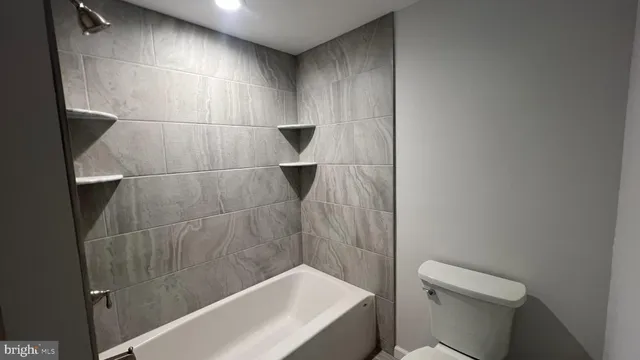 a bathroom with a toilet and shower