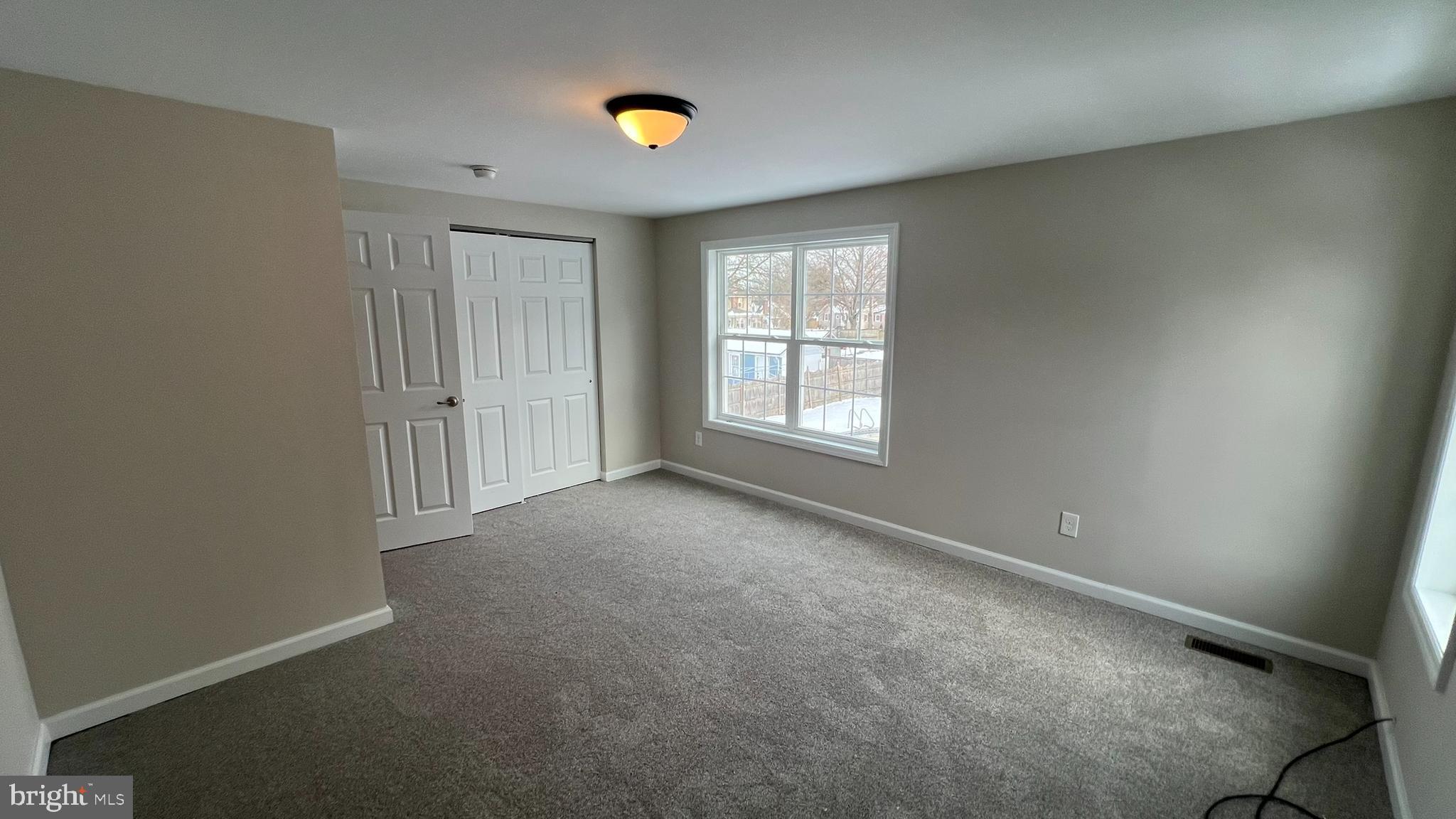 220 Harvard Avenue Stratford, NJ 08084 - Photo 31 of 33 an empty room with windows and closet