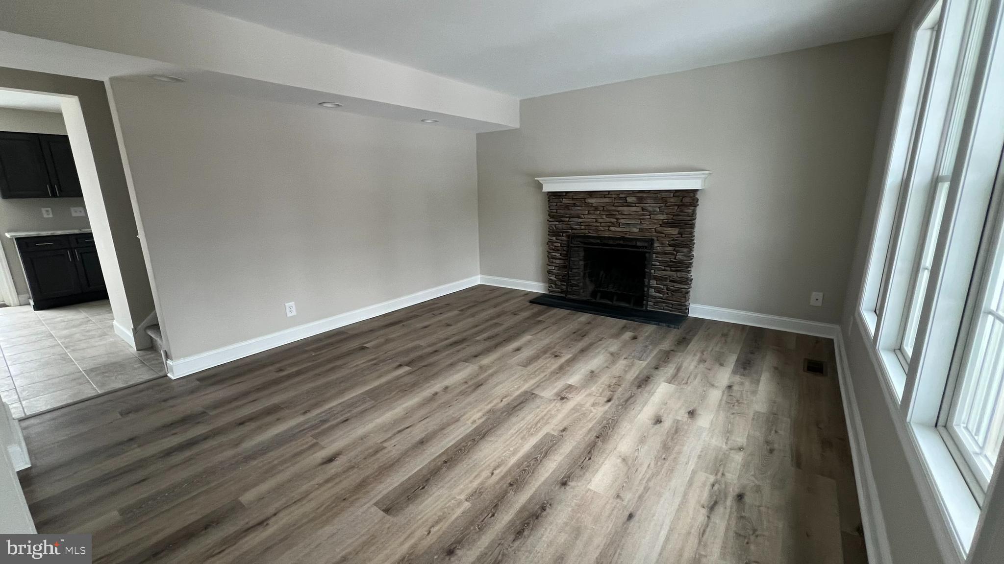 220 Harvard Avenue Stratford, NJ 08084 - Photo 4 of 33 a view of an empty room with wooden floor and a window