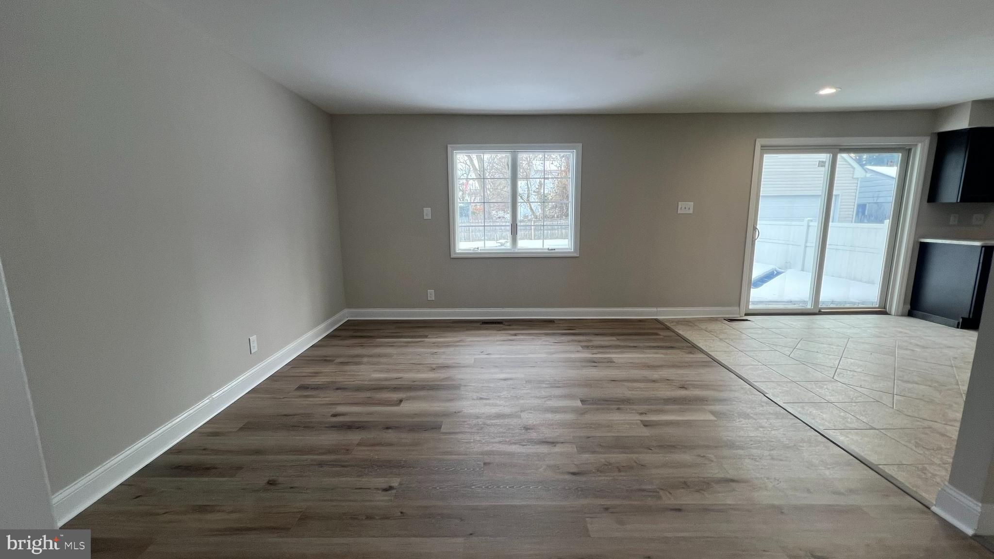 220 Harvard Avenue Stratford, NJ 08084 - Photo 9 of 33 an empty room with wooden floor and windows