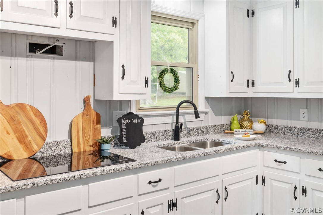 10511 Lunswood Road Chester, VA 23831 - Photo 11 of 27 Kitchen with white cabinetry, sink, and light ston