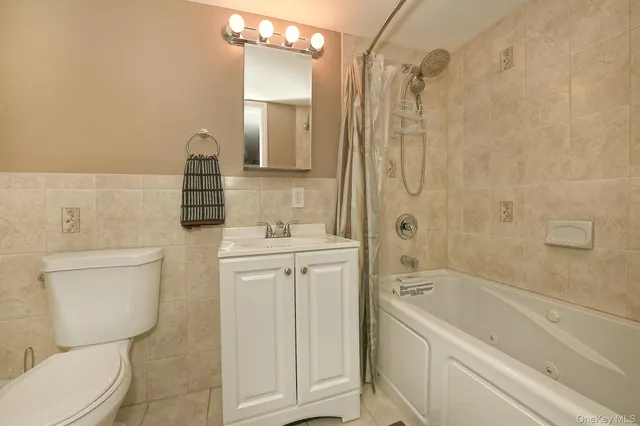 a bathroom with a granite countertop toilet a sink and bathtub