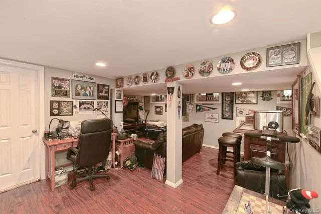 a view of a workspace with furniture and wooden floor