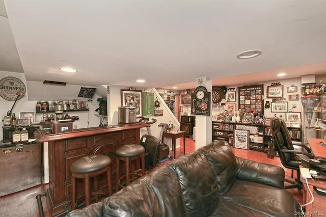 a living room with lots of furniture and a wooden floor