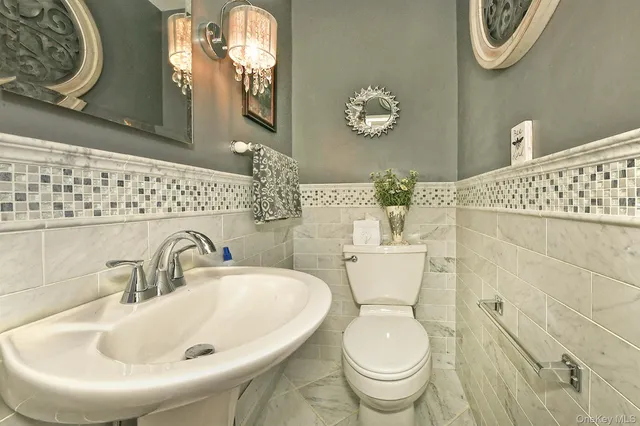 a bathroom with a toilet sink and mirror