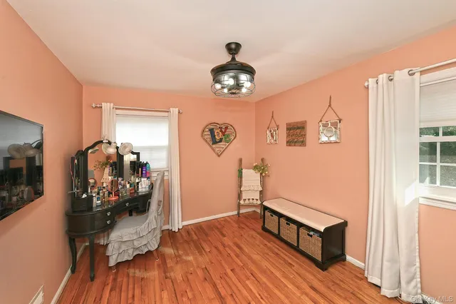 a view of a livingroom with furniture and hardwood floor
