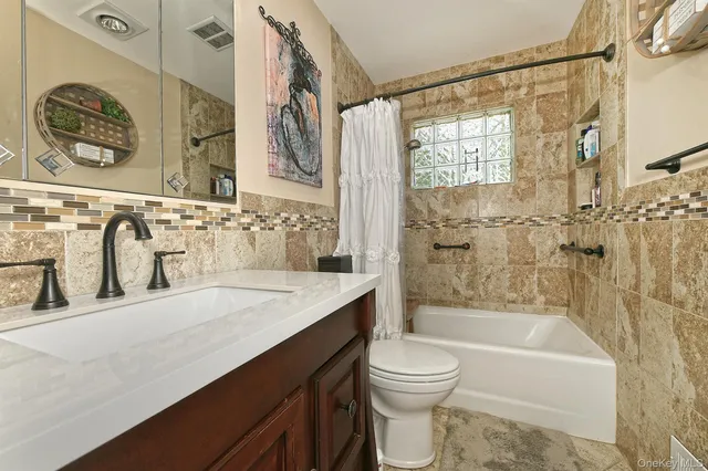 a bathroom with a sink a toilet and a bathtub