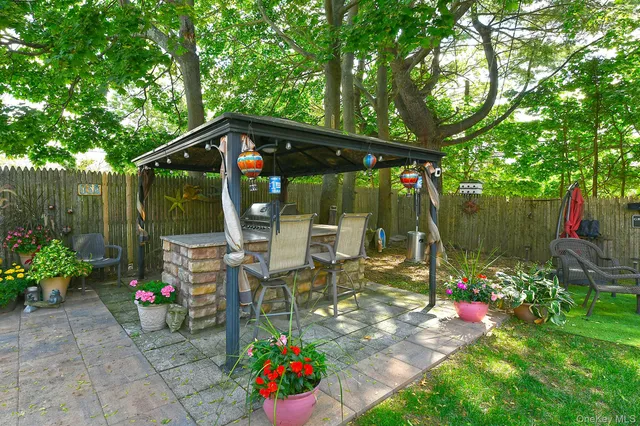 a view of outdoor dining space with a patio and a garden