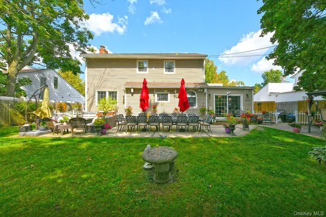 a front view of house with yard and outdoor seating
