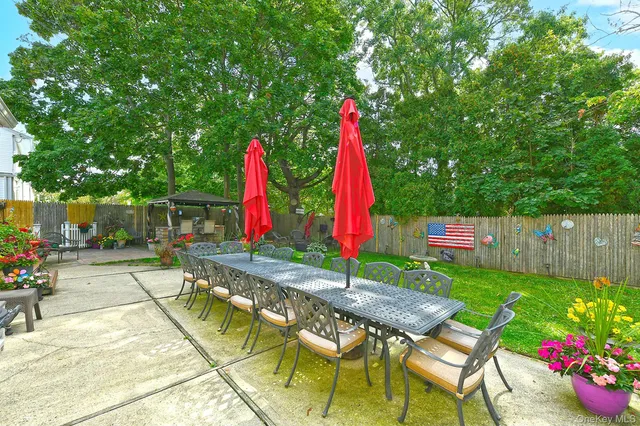 a view of backyard with swimming pool and sitting area
