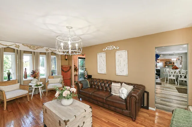 a living room with furniture and a chandelier