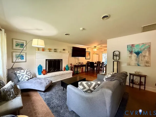 a living room with furniture and a fireplace