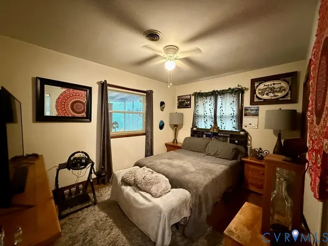 a bedroom with furniture and a wooden floor