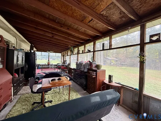 a living room with furniture a flat screen tv and kitchen view