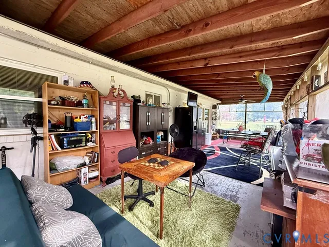 a room with musical instrument pool table furniture wooden floor and windows