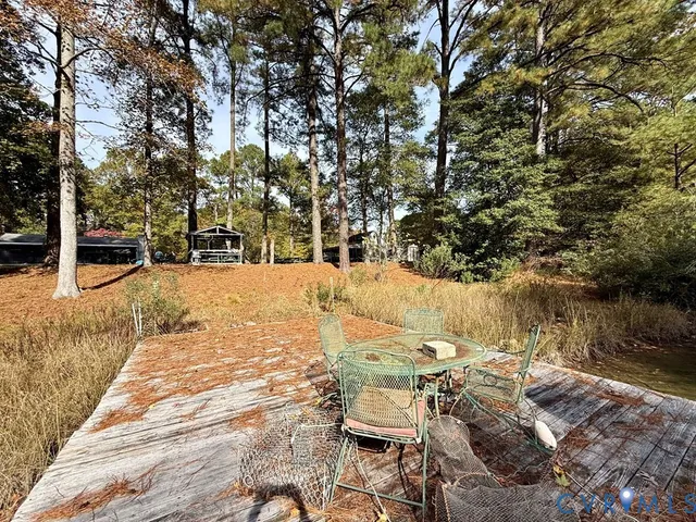 a view of backyard with wooden fence and a table and chair