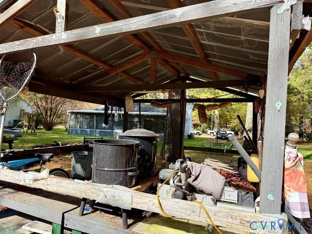 a view of a house with a yard and trees