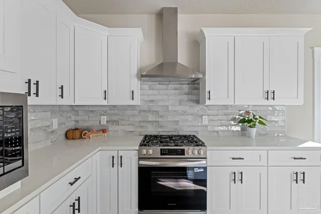 a kitchen with a sink a counter space and windows