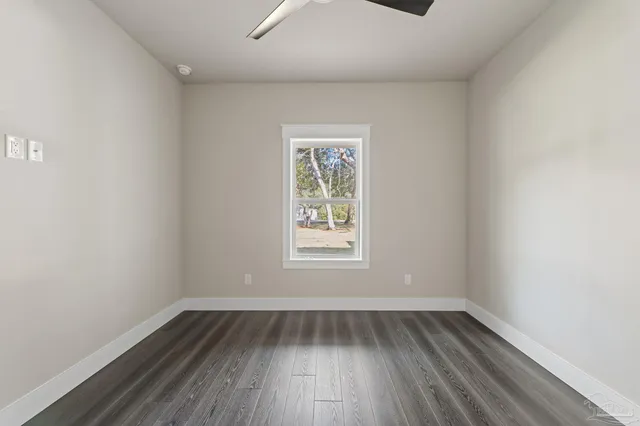 a bathroom with a tub shower sink vanity and a toilet