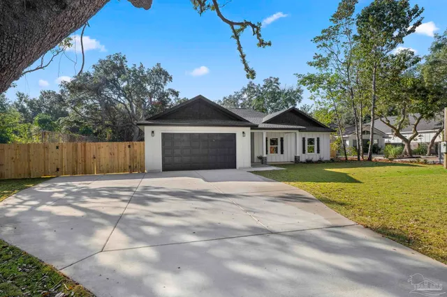a front view of a house with a garden