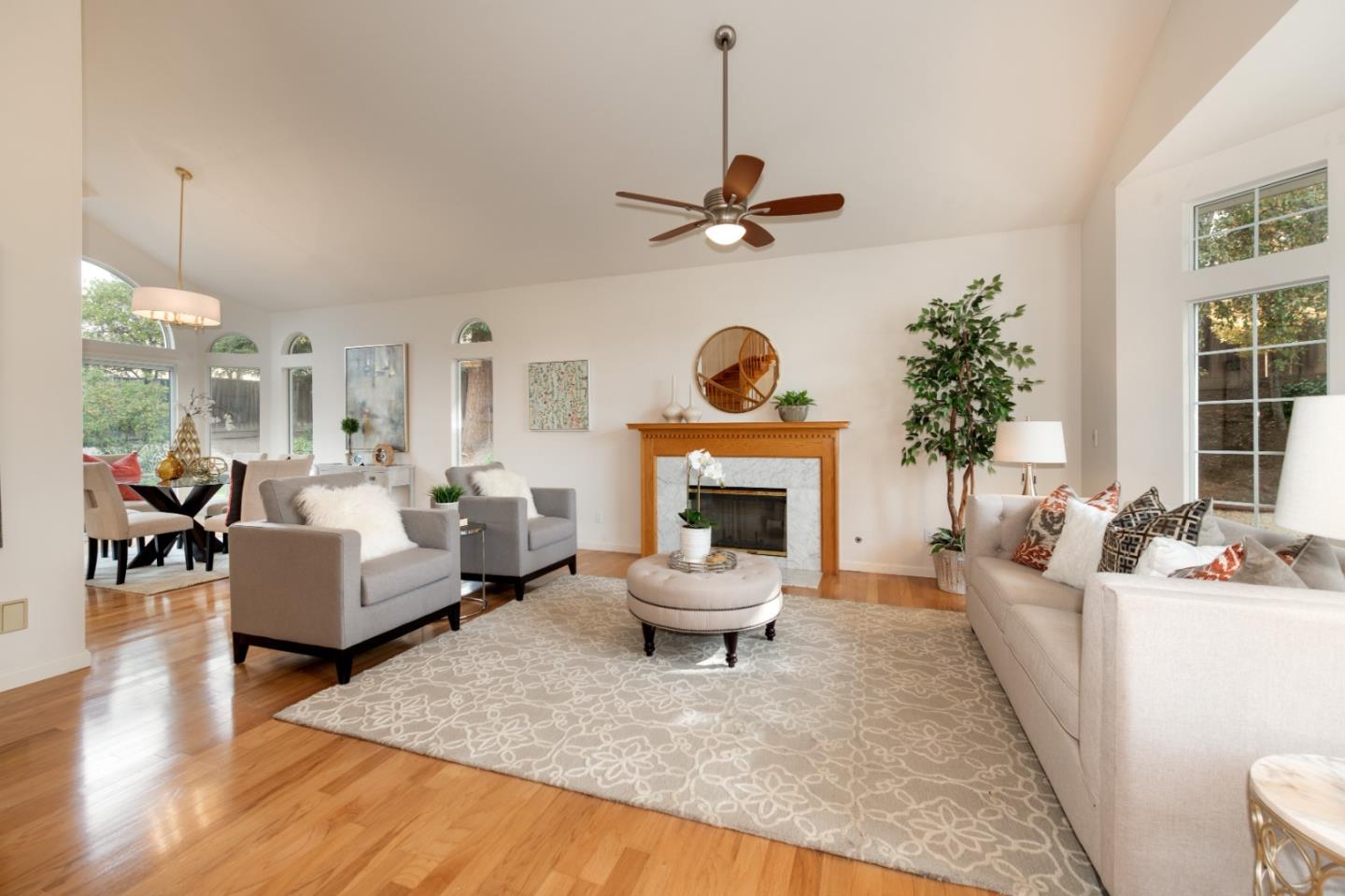 2353 Glenview Drive Milpitas, CA 95035 - Photo 4 of 20 a living room with furniture a fireplace and a chandelier
