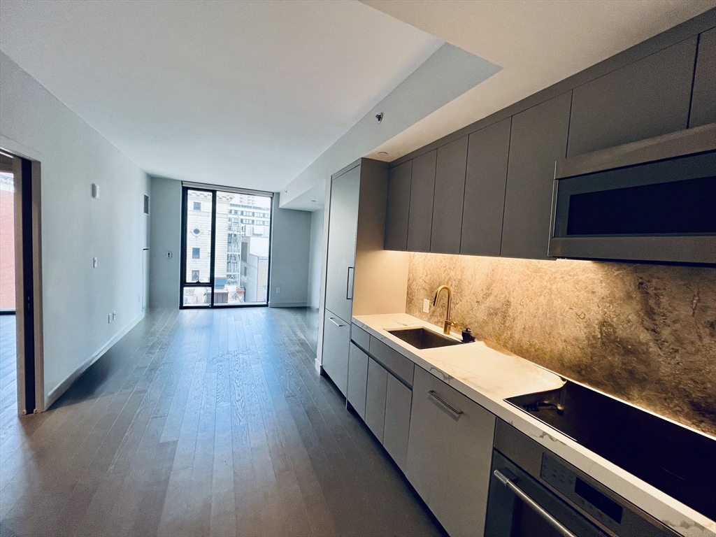 55 Lagrange Street, Unit 1108 Boston, MA 02116 - Photo 1 of 33 a kitchen with a sink and wooden floor
