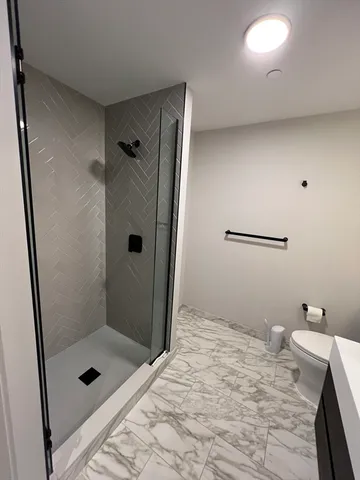 a bathroom with a sink toilet and mirror