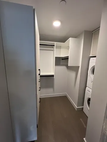 a view of walk in closet with empty racks