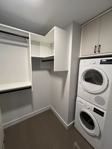 a view of walk in closet with clothes