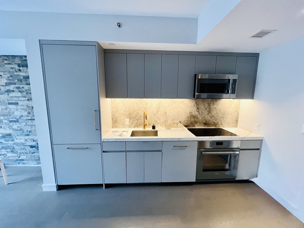55 Lagrange Street, Unit 1108 Boston, MA 02116 - Photo 2 of 33 a kitchen with stainless steel appliances a stove a microwave and a refrigerator