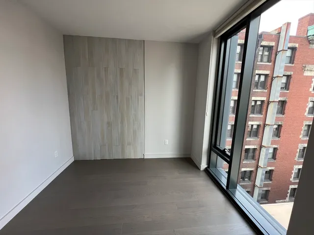 an empty room with wooden floor and door