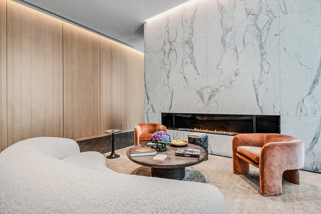 55 Lagrange Street, Unit 1108 Boston, MA 02116 - Photo 27 of 33 a living room with furniture and a fireplace